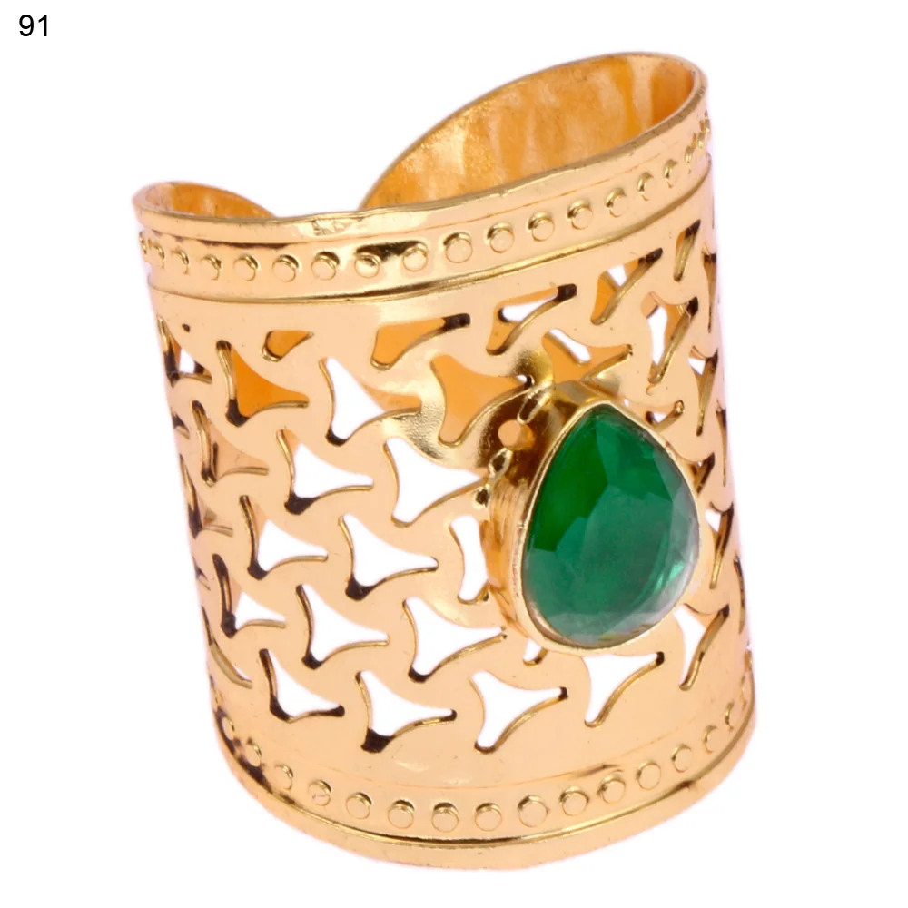 Gold-plated brass adjustable ring with a three-pointed dart openwork band and a single bezel-set faceted green stone