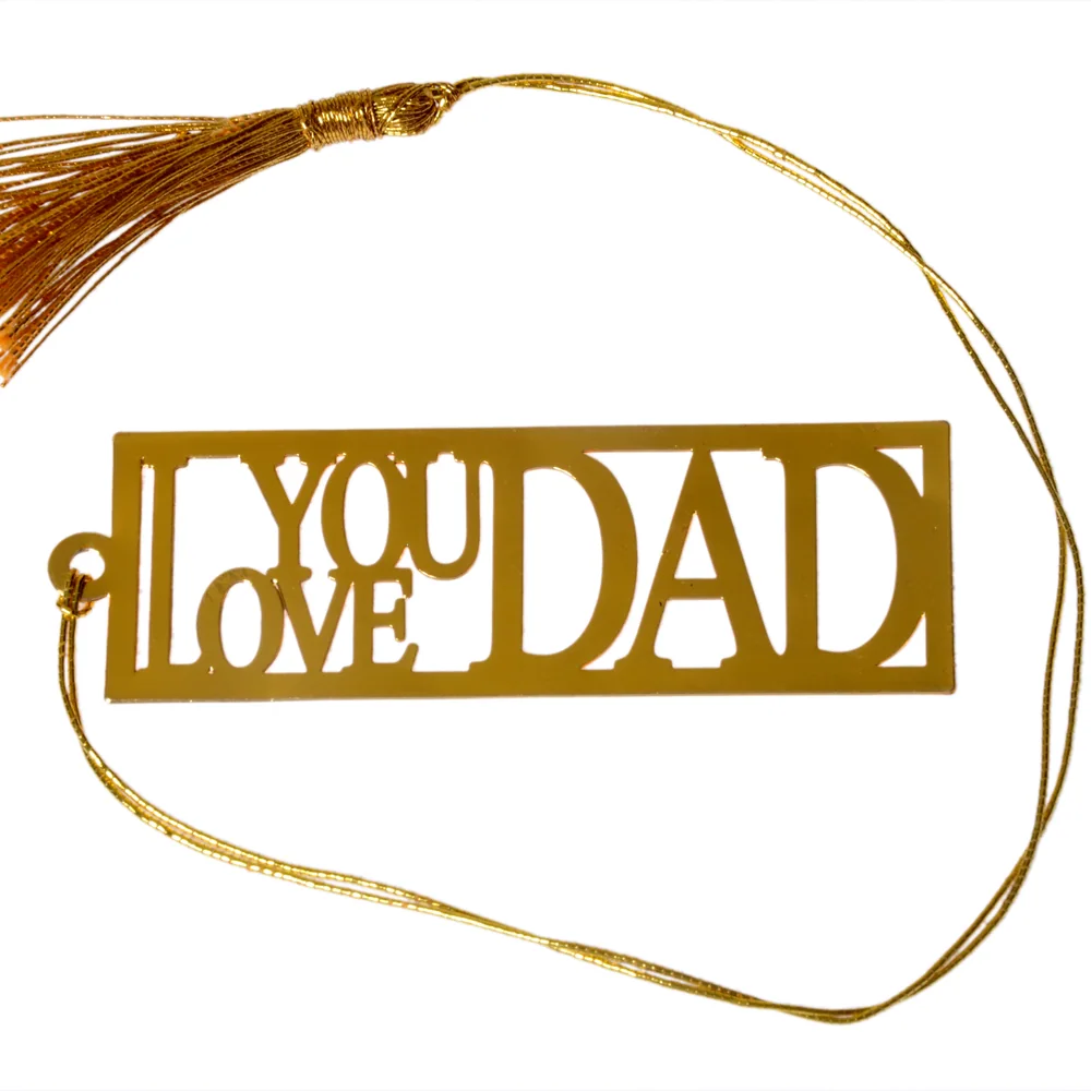 Die-cut gold-tone bookmark reading I Love You Dad in stacked block lettering inside a rectangular frame, on a gold cord with a tassel