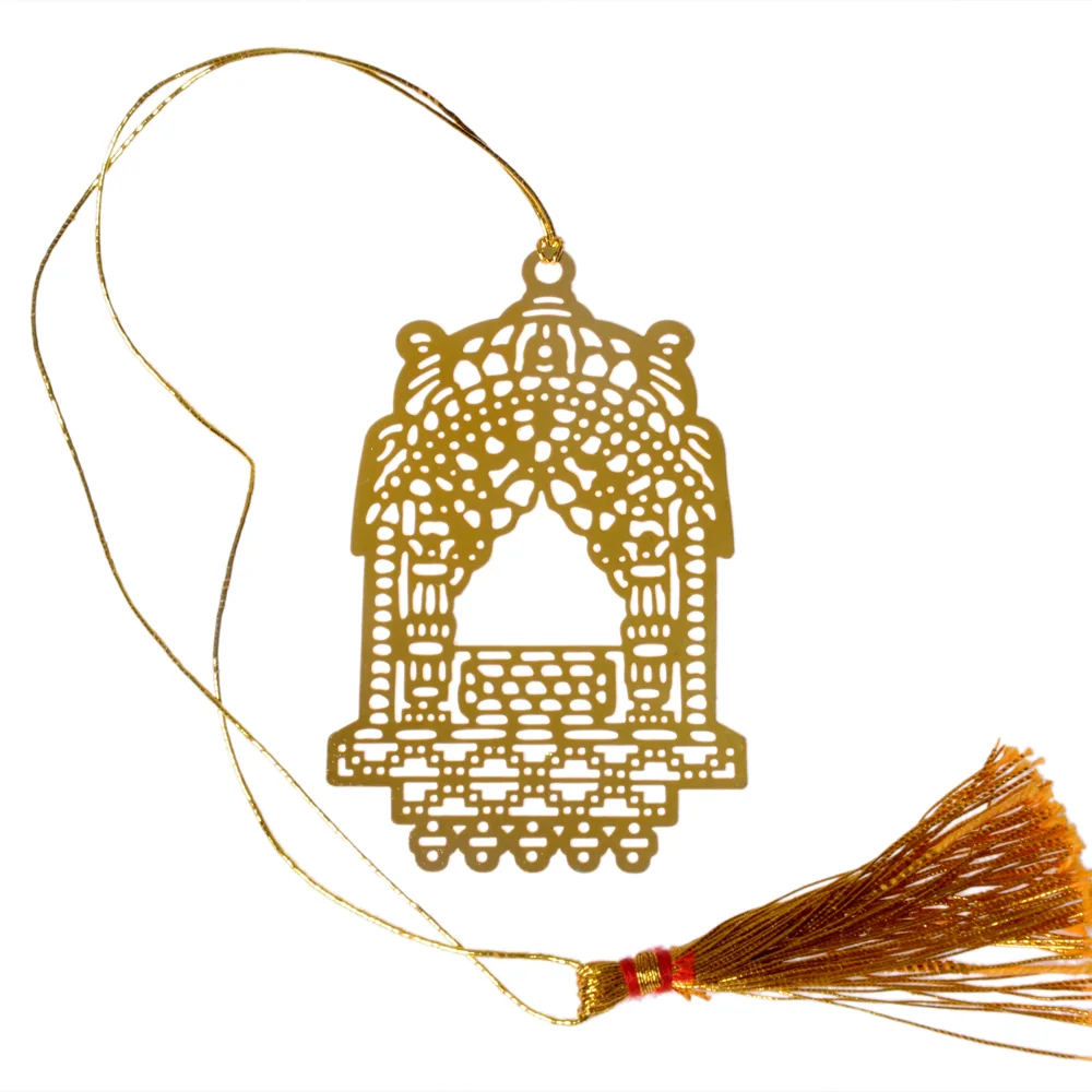 Die-cut gold-tone bookmark of a jharokha shrine canopy in dense lacework, with pierced pillars, a domed arch and a stepped base, on a gold cord with a tassel
