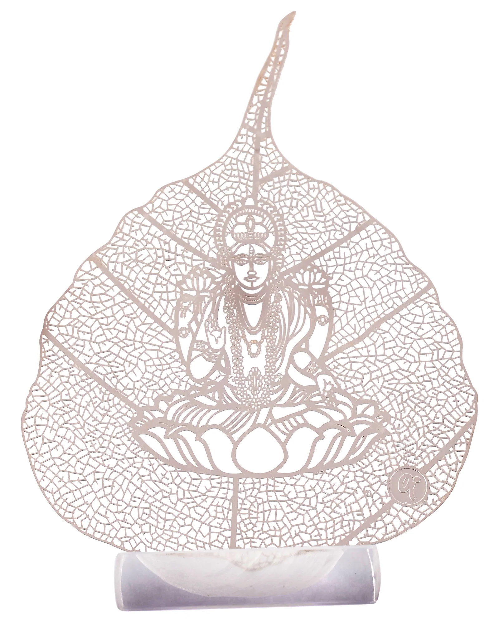 Silver skeletonised peepal leaf engraved with the goddess Lakshmi seated on an open lotus, standing in a clear acrylic pedestal