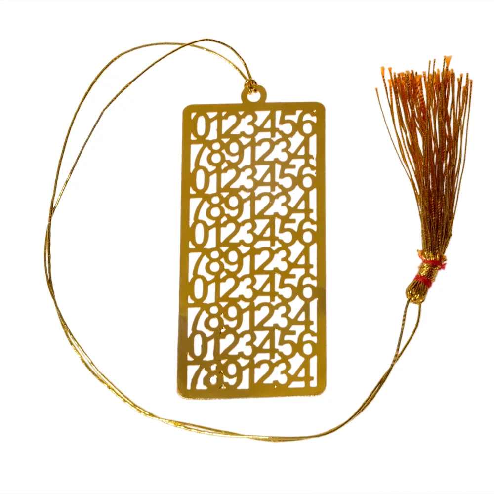 Die-cut gold-tone bookmark of the numerals nought to nine cut in rows and repeated down the plate, on a gold cord with a tassel