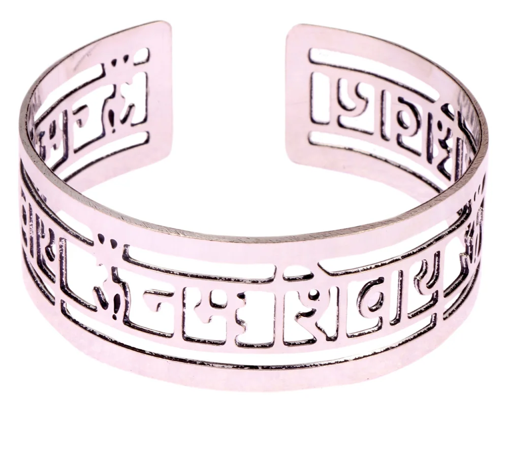 Open rhodium-plated cuff bangle in bright white metal, pierced with ॐ नमः शिवाय in Devanagari, one syllable to a cell across the front band