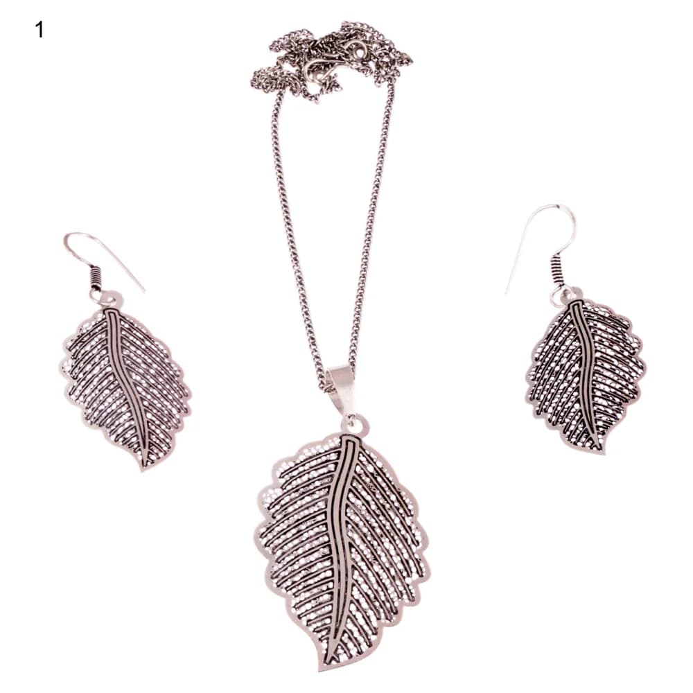 Oxidised silver three-piece set with a leaf pendant and matching hook earrings, a bold solid midrib running between beaded rows of straight ribs inside a scalloped edge