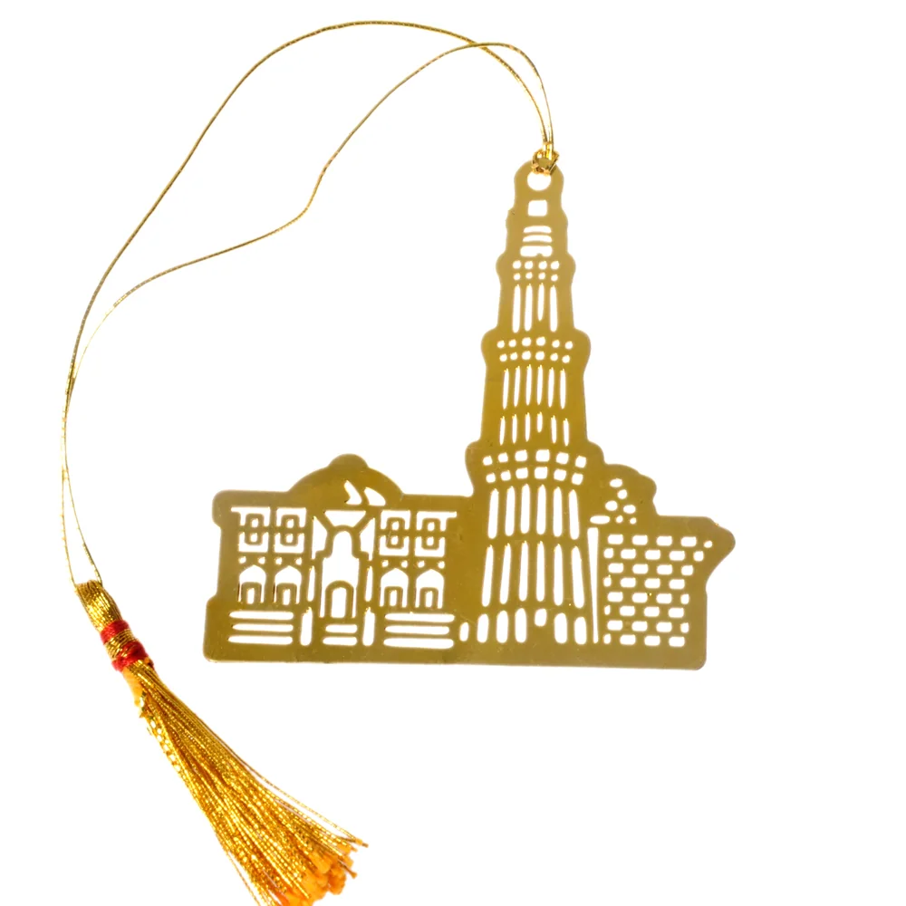Die-cut gold-tone bookmark of the Qutub Minar with its fluted balconies, beside the low arcaded buildings of the complex, on a gold cord with a tassel