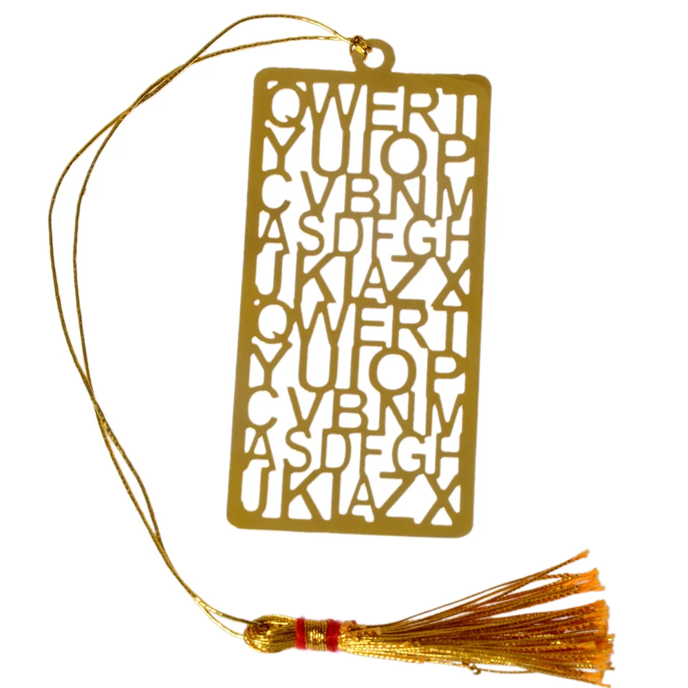 Die-cut gold-tone bookmark of the capital alphabet laid out in QWERTY keyboard rows, repeated twice down the plate, on a gold cord with a tassel