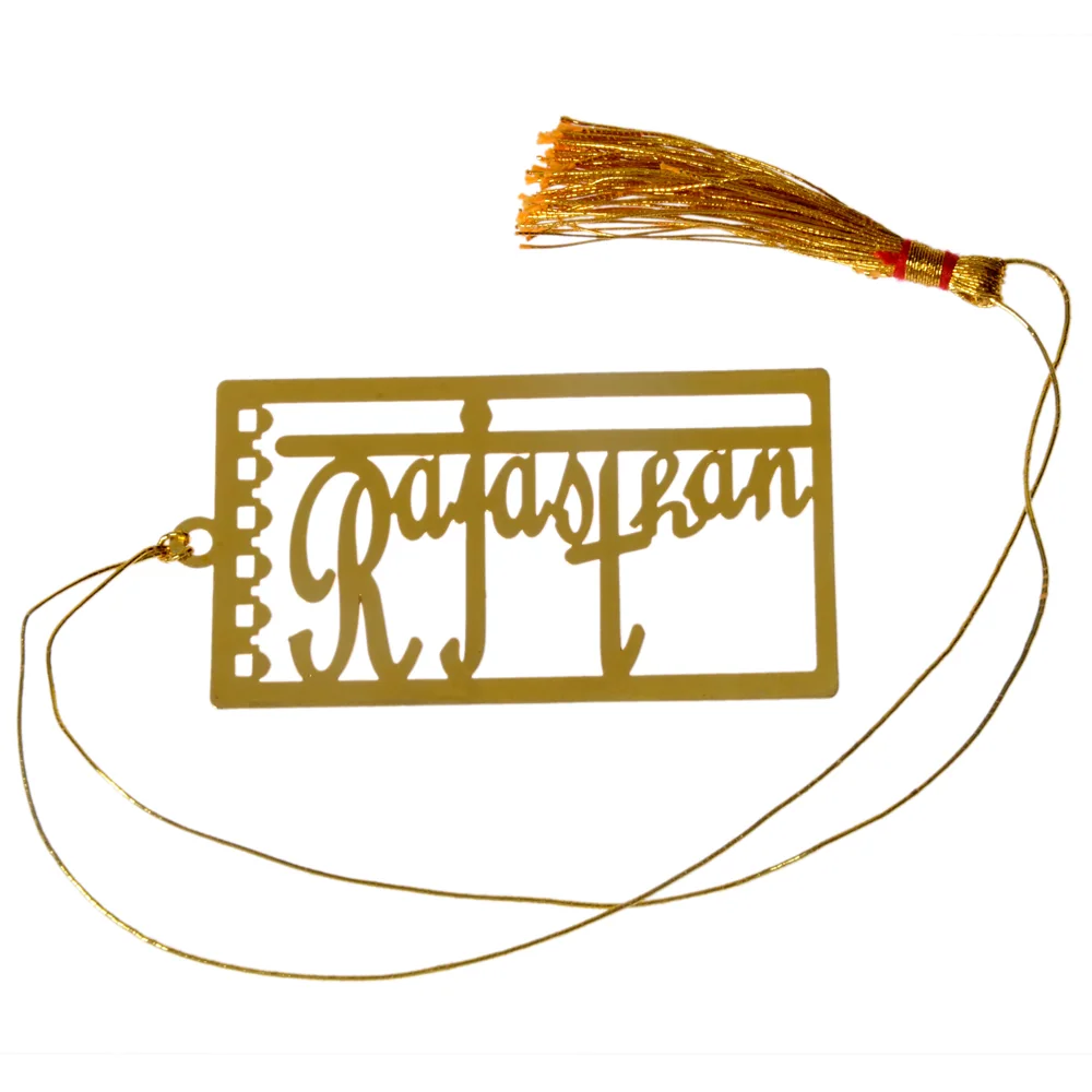 Die-cut gold-tone bookmark reading Rajasthan in a joined script across a plate shaped like a spiral-bound page, on a gold cord with a tassel