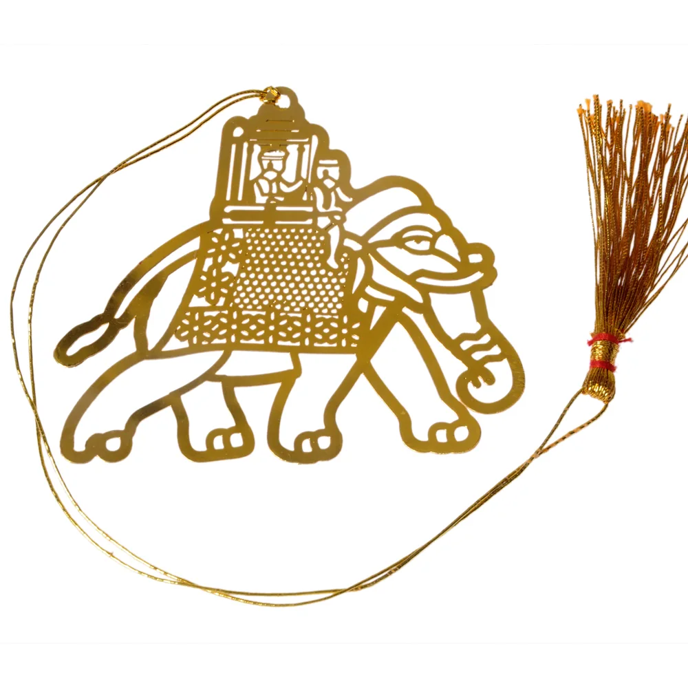 Die-cut gold-tone bookmark of a caparisoned elephant carrying a canopied howdah with two riders, its blanket cut in lattice, on a gold cord with a tassel