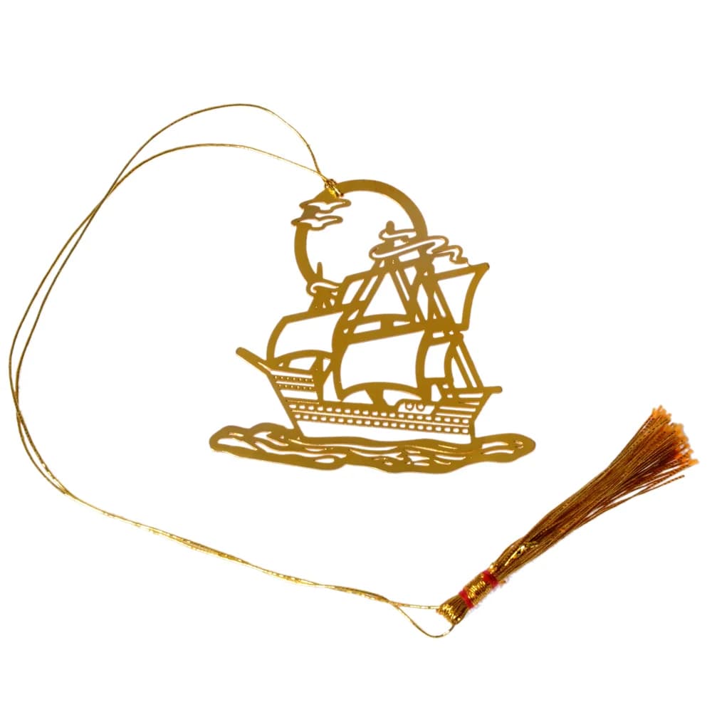 Die-cut gold-tone bookmark of a square-rigged sailing ship under full sail on cut waves, a sun and cloud behind it, on a gold cord with a tassel