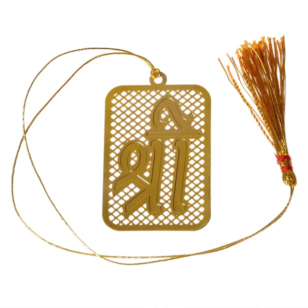 Die-cut gold-tone bookmark of the Devanagari syllable Shree raised over a rectangle of pierced diamond lattice, on a gold cord with a tassel