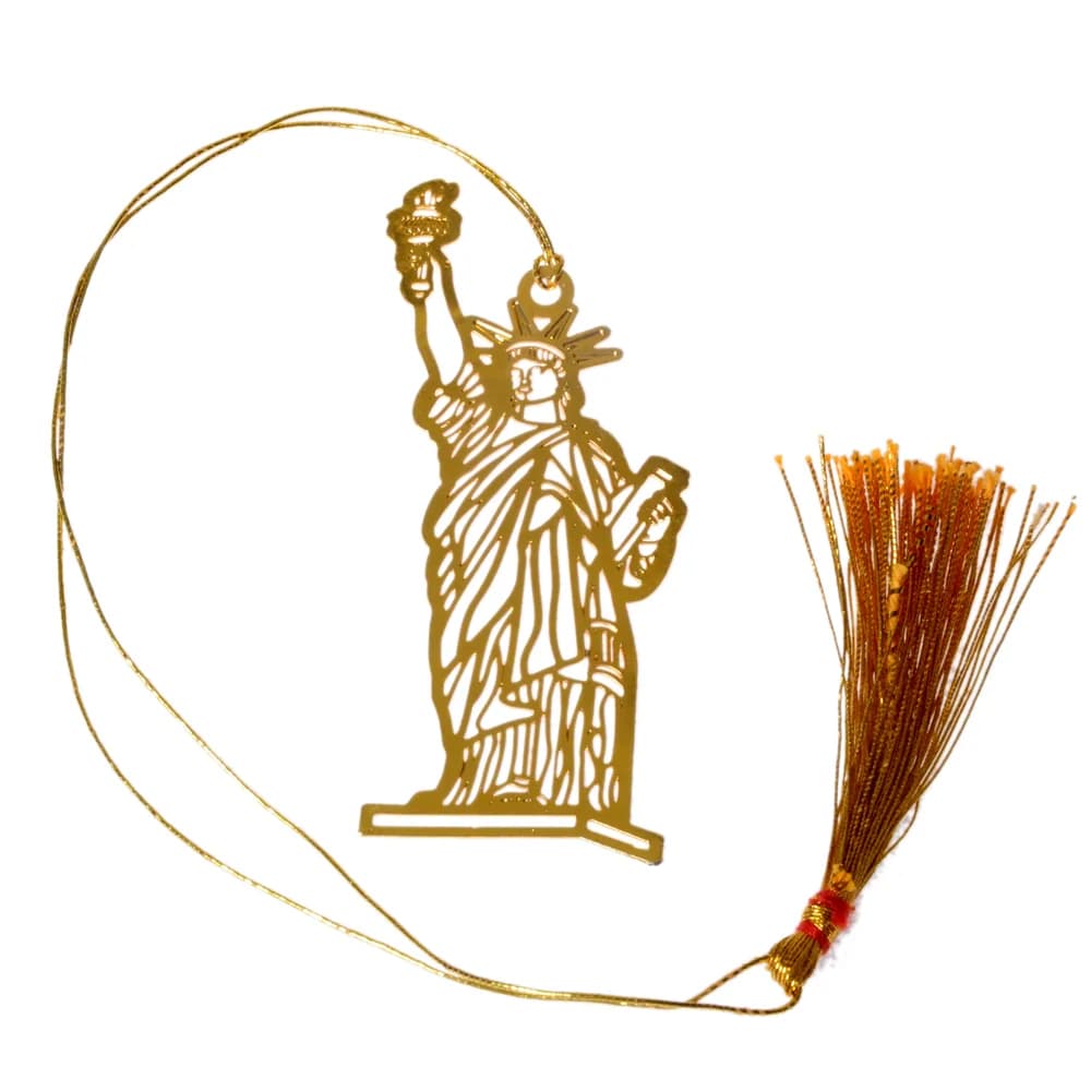 Die-cut gold-tone bookmark of the Statue of Liberty with her torch raised and tablet held, on a gold cord with a tassel
