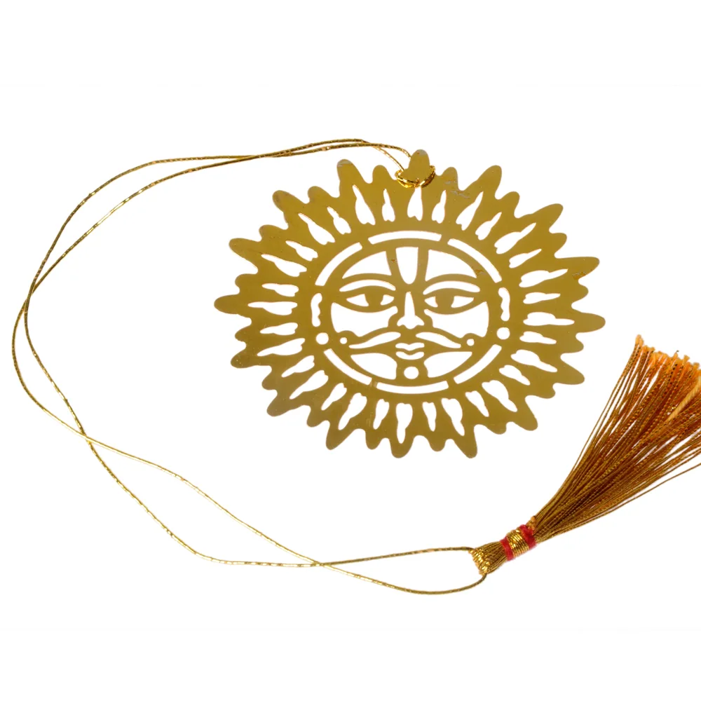 Die-cut gold-tone bookmark of a sun face with a moustache ringed by flame-shaped rays, on a gold cord with a tassel