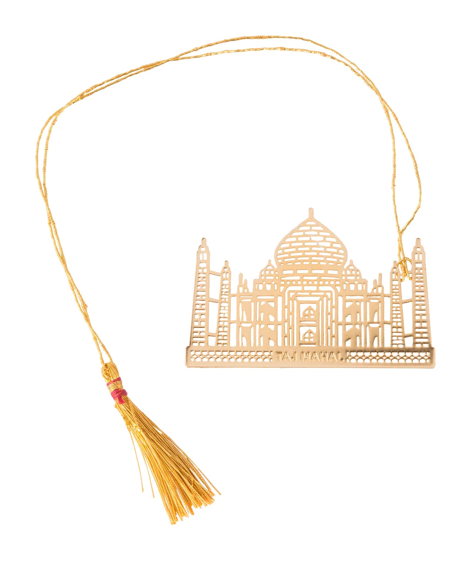 Wide die-cut gold bookmark of the Taj Mahal with dome, four minarets and a pierced railing plinth, laid out with its gold cord and tassel