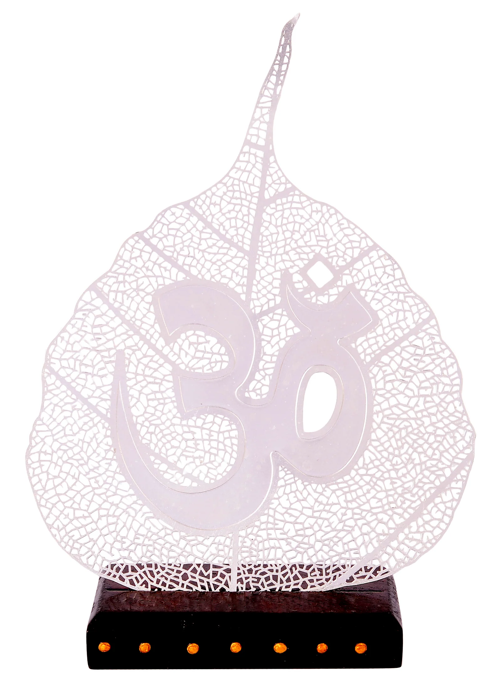 Silver skeletonised peepal leaf carrying a large raised Aum, mounted on a dark wooden base studded with gold dots