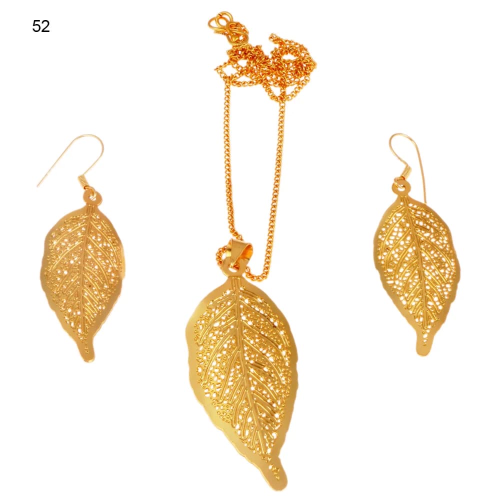 Gold-plated three-piece set with a leaf pendant and matching hook earrings, its filigree worked in raised beading and drawn out into a curling drip tip
