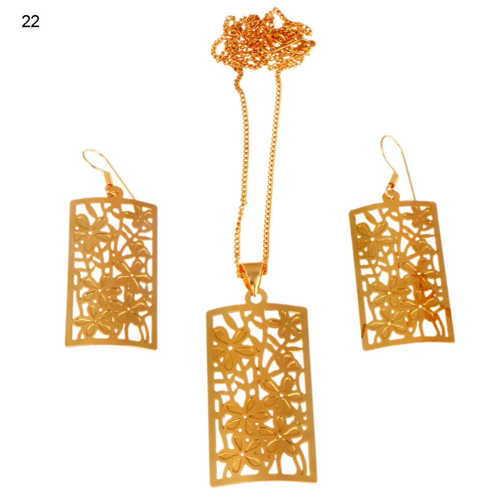 Gold-plated three-piece set with an upright rectangular panel pendant and matching hook earrings, massed with five-petal blossoms and dished gently across its width