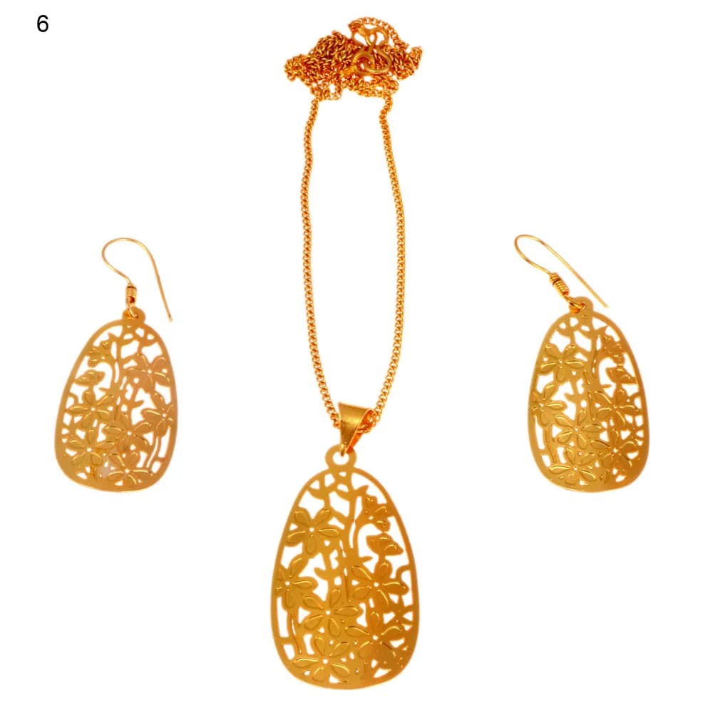 Gold-plated three-piece set with a teardrop plaque pendant and matching hook earrings, pierced with five-petal blossoms and a butterfly on a trailing stem