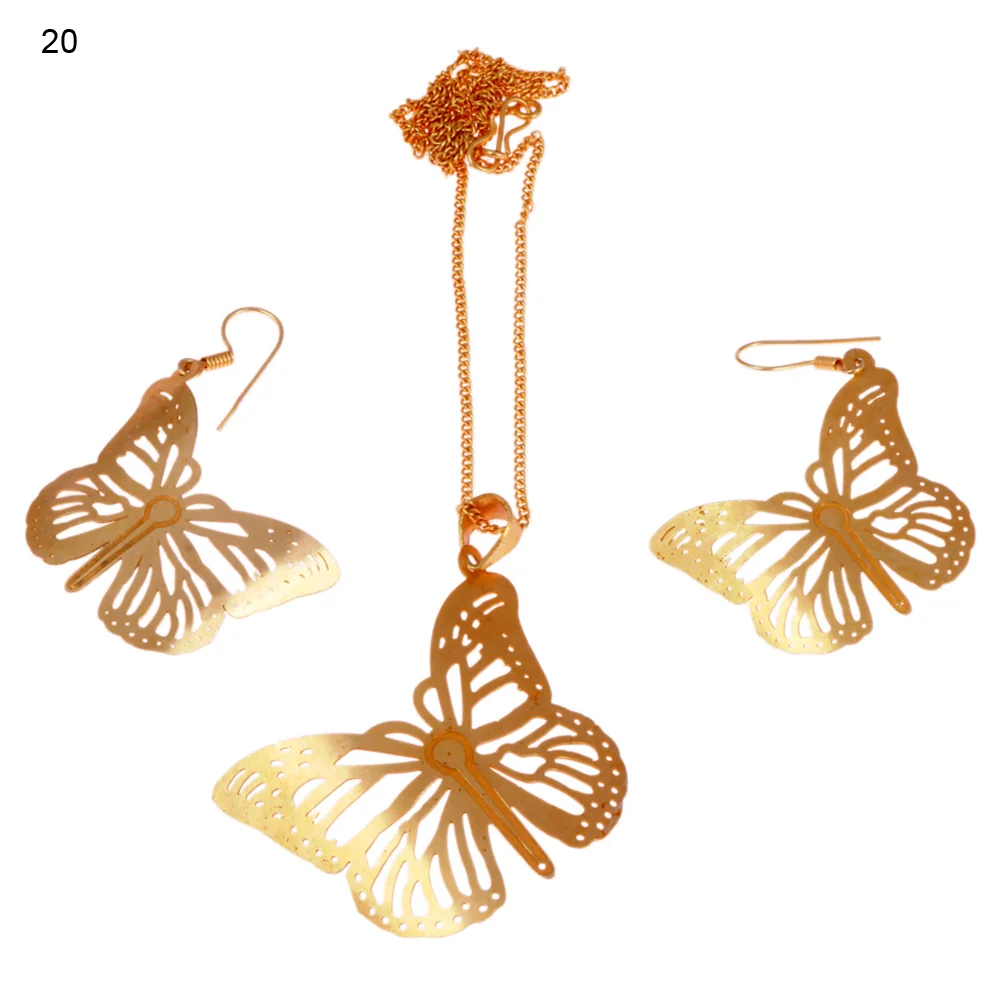 Gold-plated three-piece set with a butterfly pendant and matching hook earrings, the wings pierced with teardrop cells inside a border of small round dots