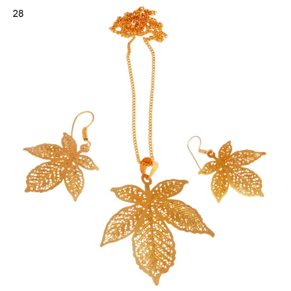 Gold-plated three-piece set with a compound leaf pendant and matching hook earrings, five separate leaflets radiating from one stem and each veined in fine lace