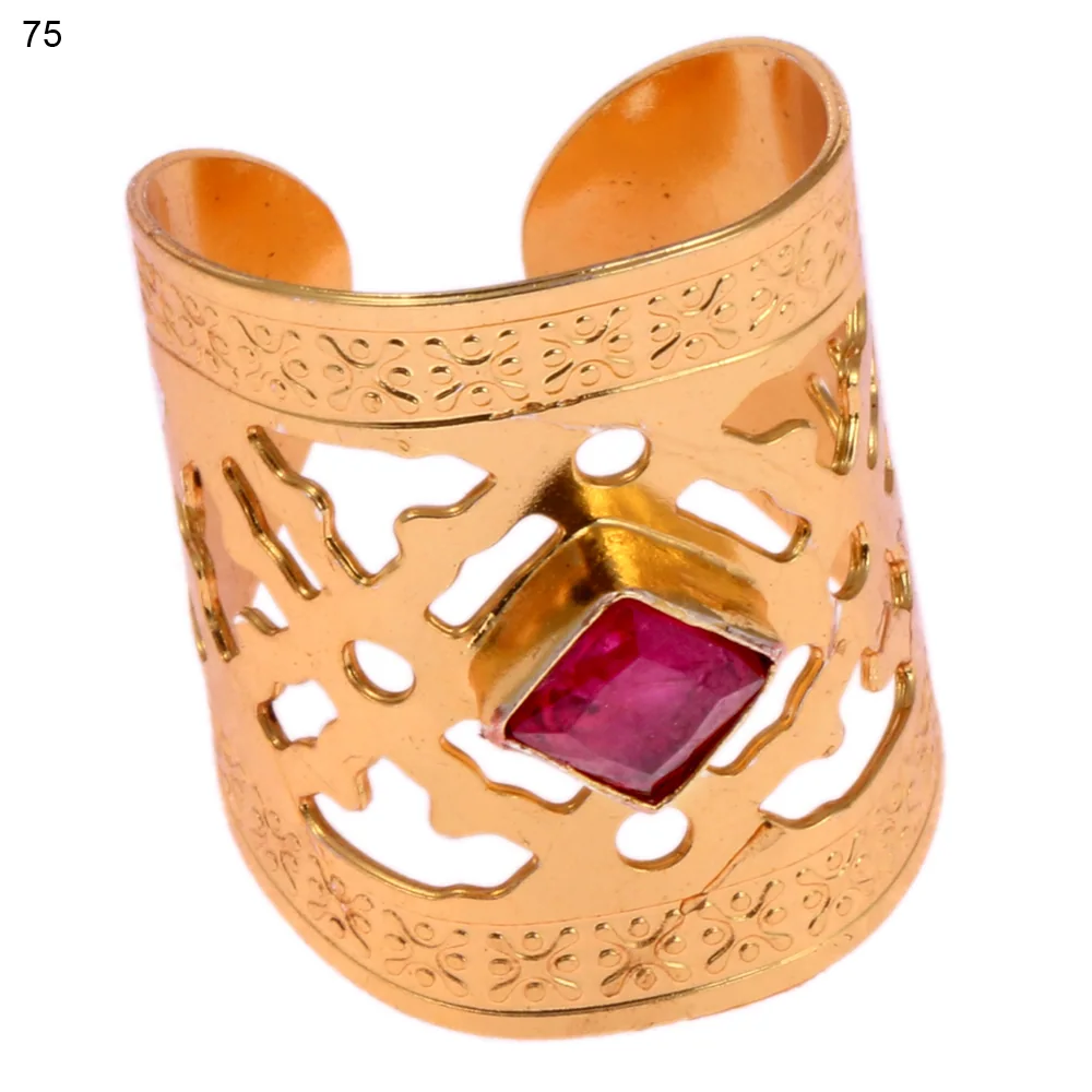 Gold-plated brass adjustable ring with a interlocking cross-and-dot openwork band and a single bezel-set faceted red stone