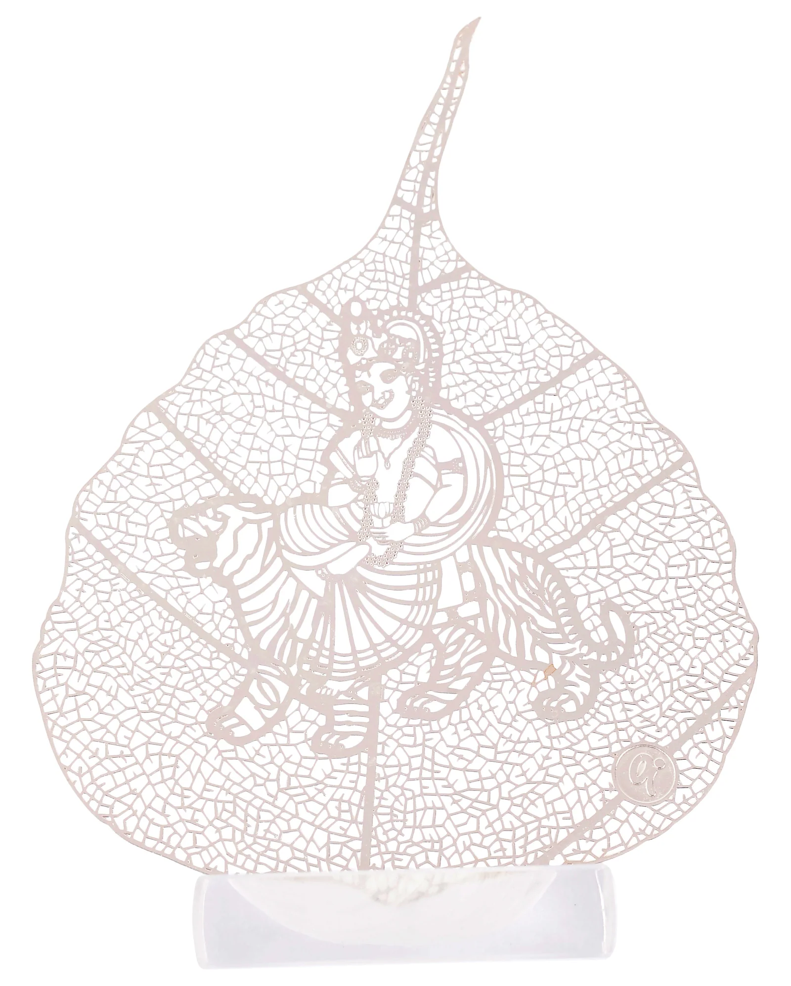 Silver skeletonised peepal leaf engraved with a crowned deity standing in a pleated robe and beaded garland, an animal couchant at each side, in a clear acrylic pedestal