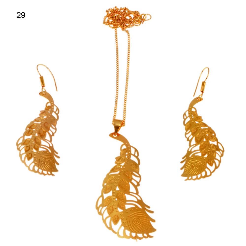 Gold-plated three-piece set with a curved peacock feather pendant and matching hook earrings, its spine beaded and its barbs cut as small leaves around an engraved eye