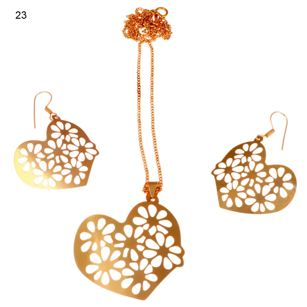 Gold-plated three-piece set with a heart pendant and matching hook earrings, cut away into overlapping daisy heads until almost nothing solid is left