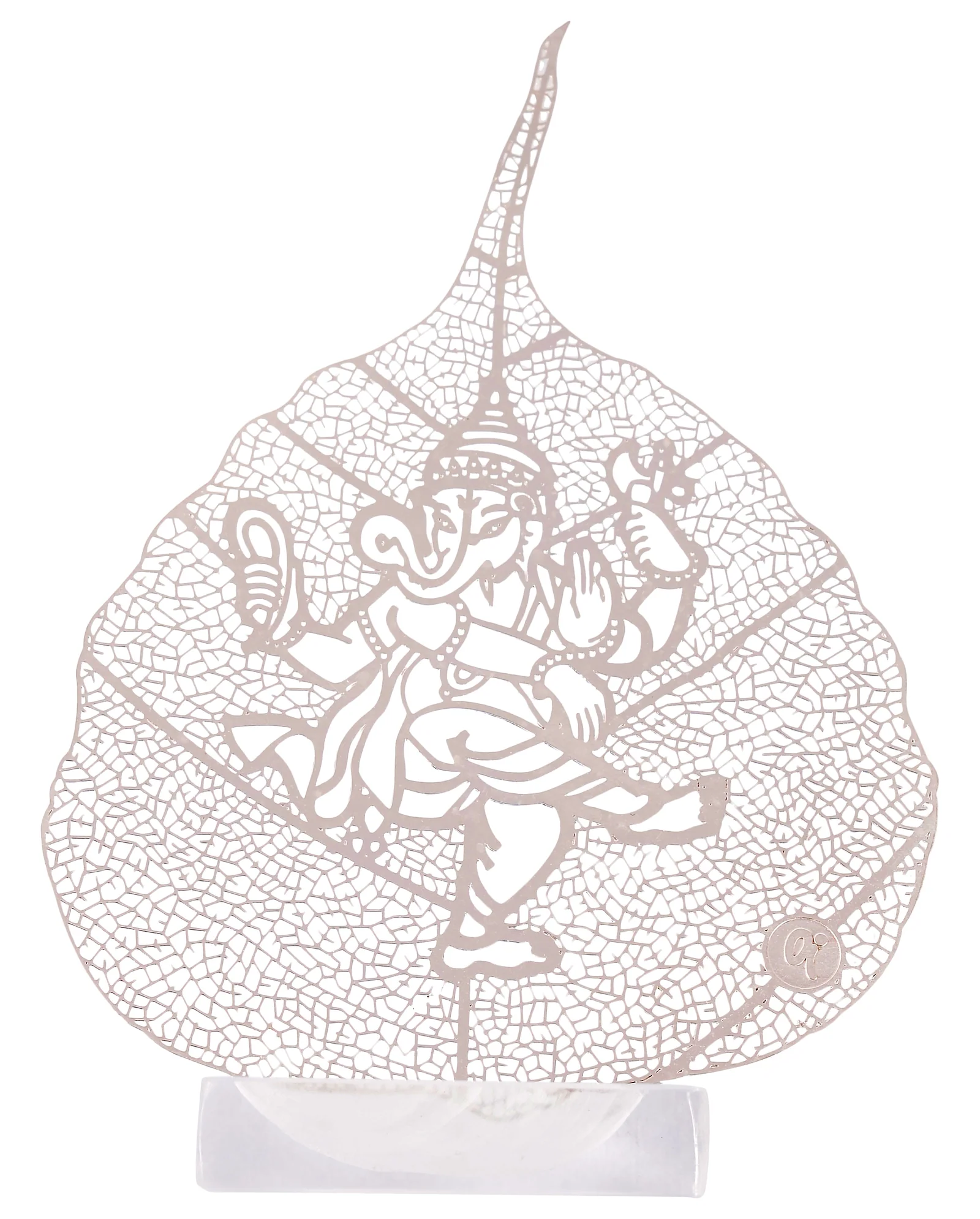 Silver skeletonised peepal leaf engraved with four-armed Ganesha in a dancing pose, standing in a clear acrylic pedestal