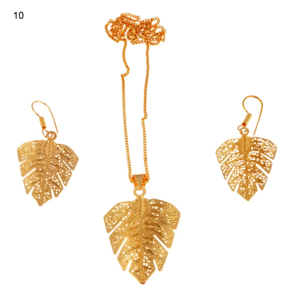 Gold-plated three-piece set with a split-lobed monstera leaf pendant and matching hook earrings, its ribs surrounded by a coarse dotted net