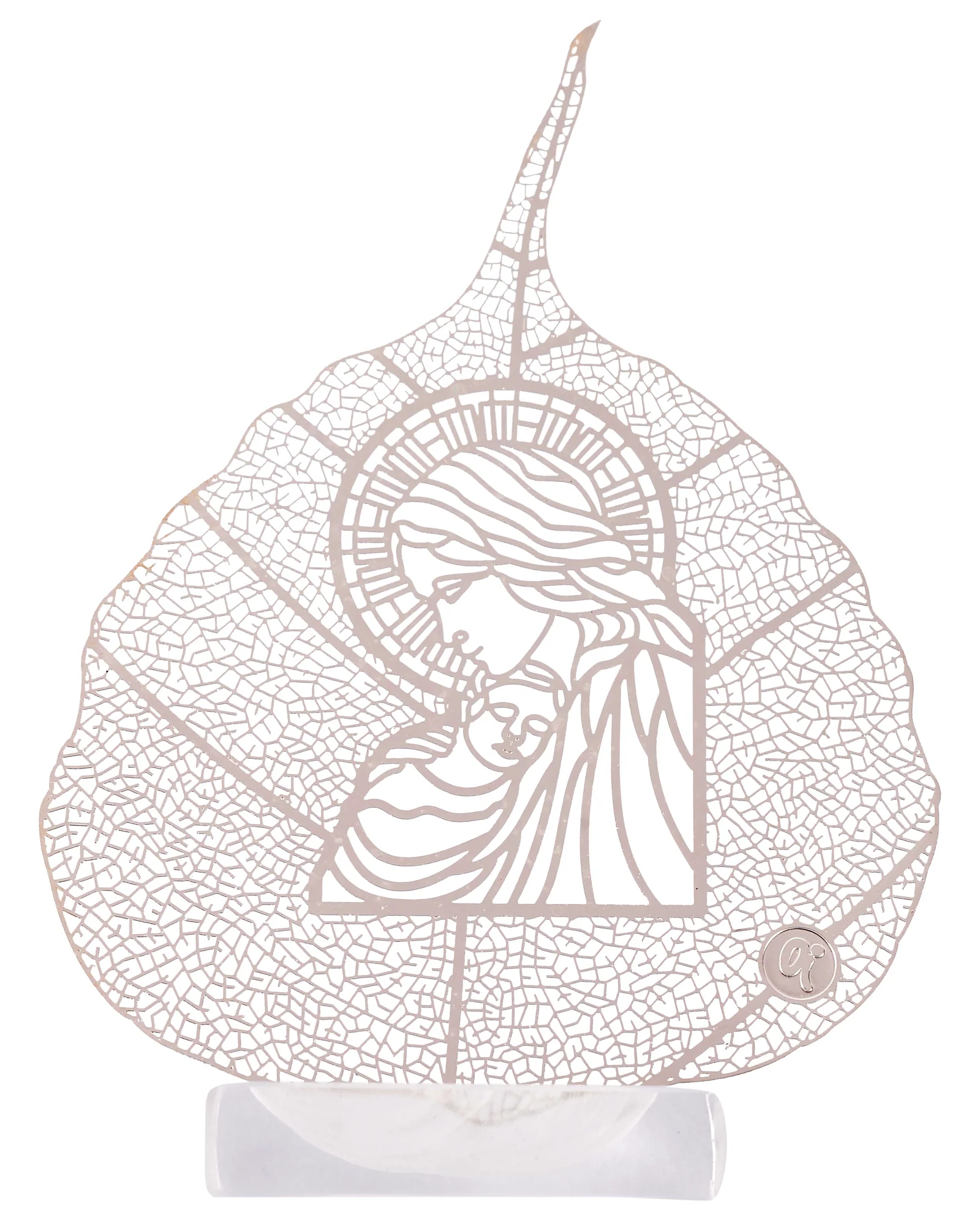 Silver skeletonised peepal leaf engraved with the Madonna holding the infant Christ, standing in a clear acrylic pedestal