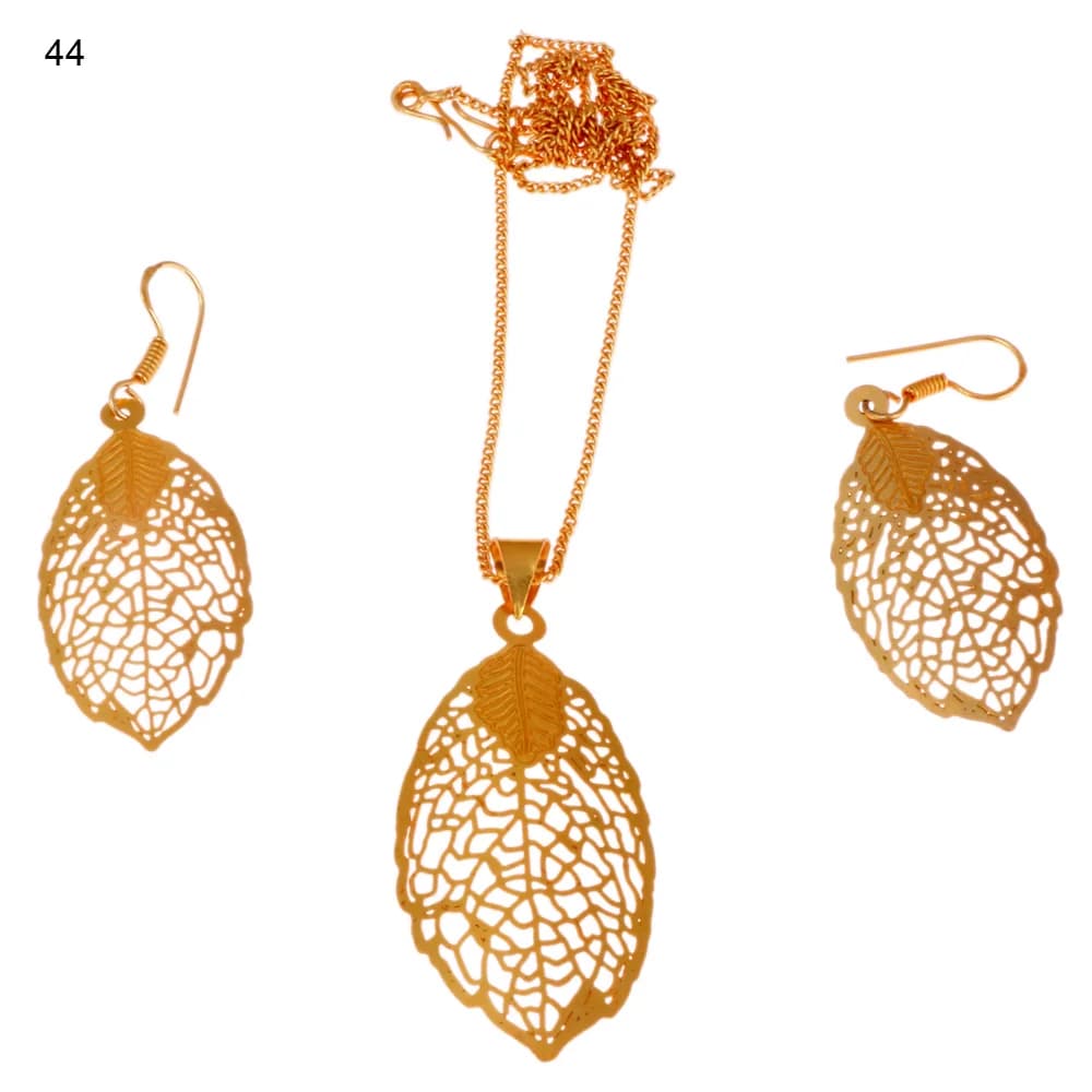 Gold-plated three-piece set with a pointed oval leaf pendant and matching hook earrings, a small solid leaf laid over the stem of each of the three pieces