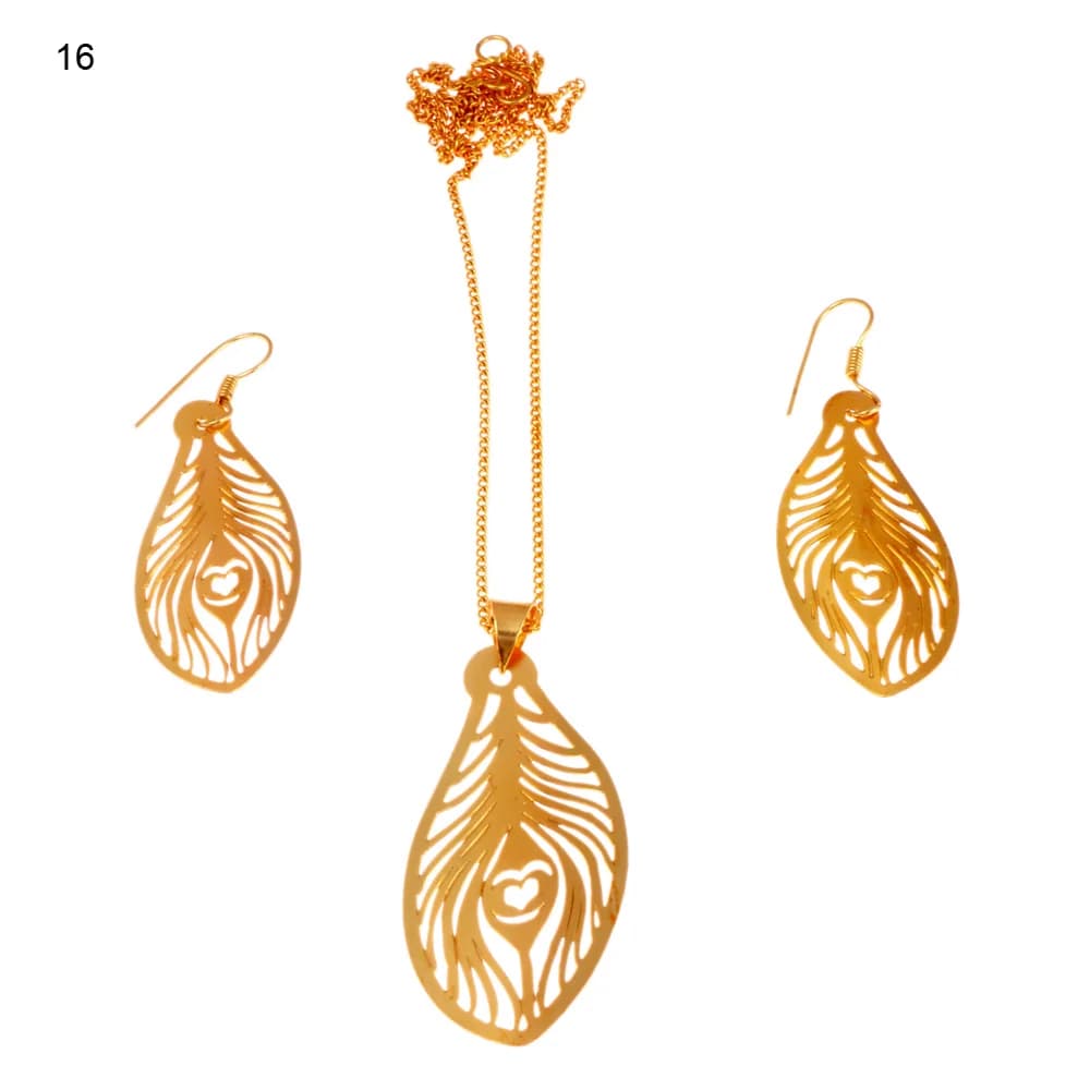 Gold-plated three-piece set with a peacock feather pendant and matching hook earrings, the barbs swept back around a small heart-shaped eye on a stem