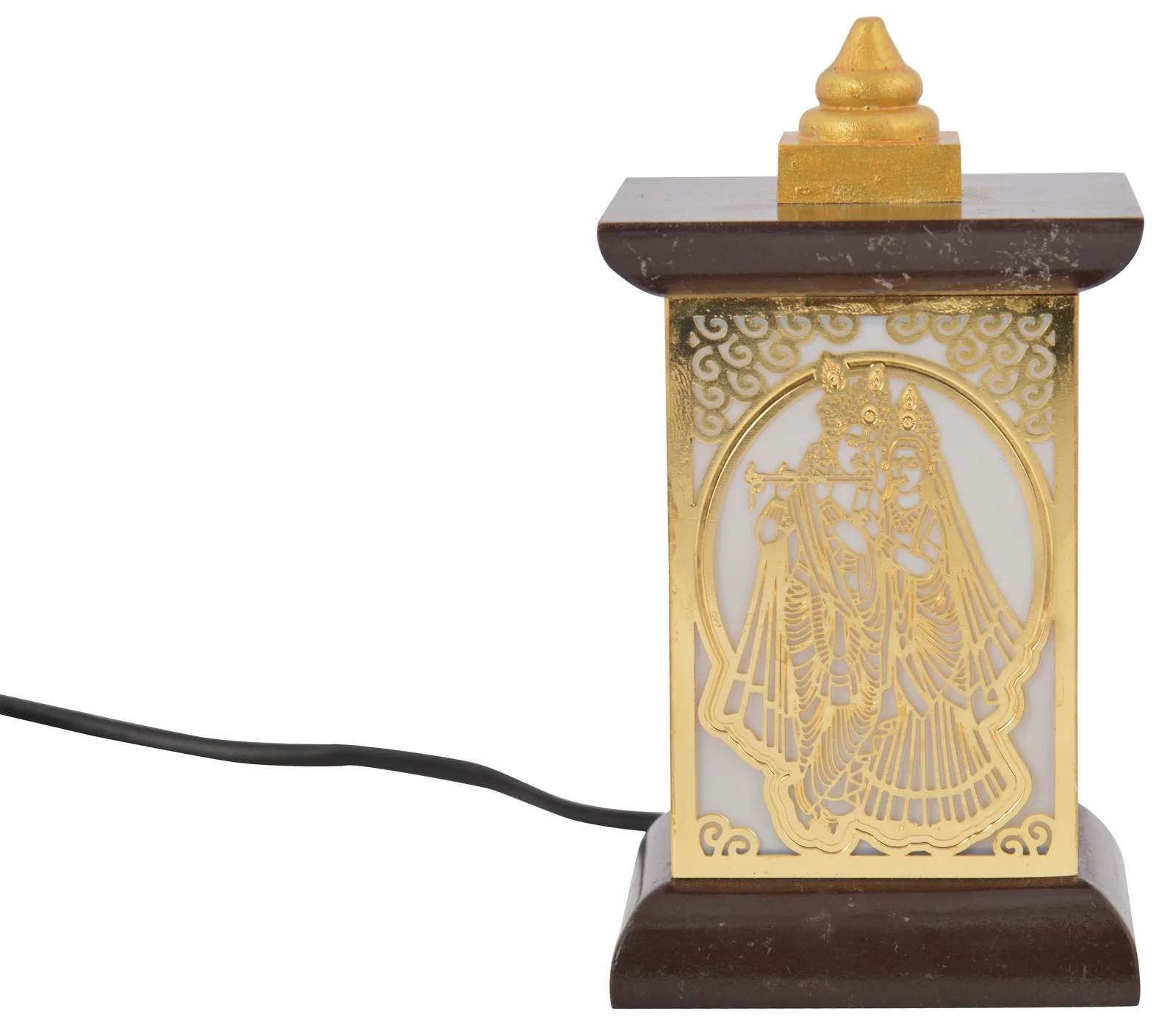 Wooden pagoda-frame table lamp with a pierced brass panel of Radha and Krishna under a scalloped arch, unlit on white