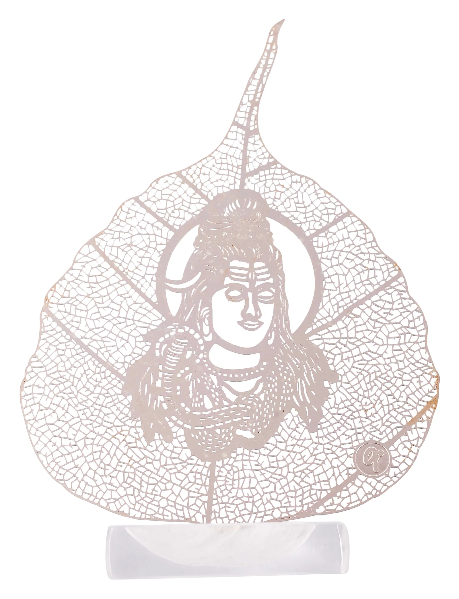 Silver skeletonised peepal leaf engraved with the face of Shiva inside a plain halo ring, standing in a clear acrylic pedestal