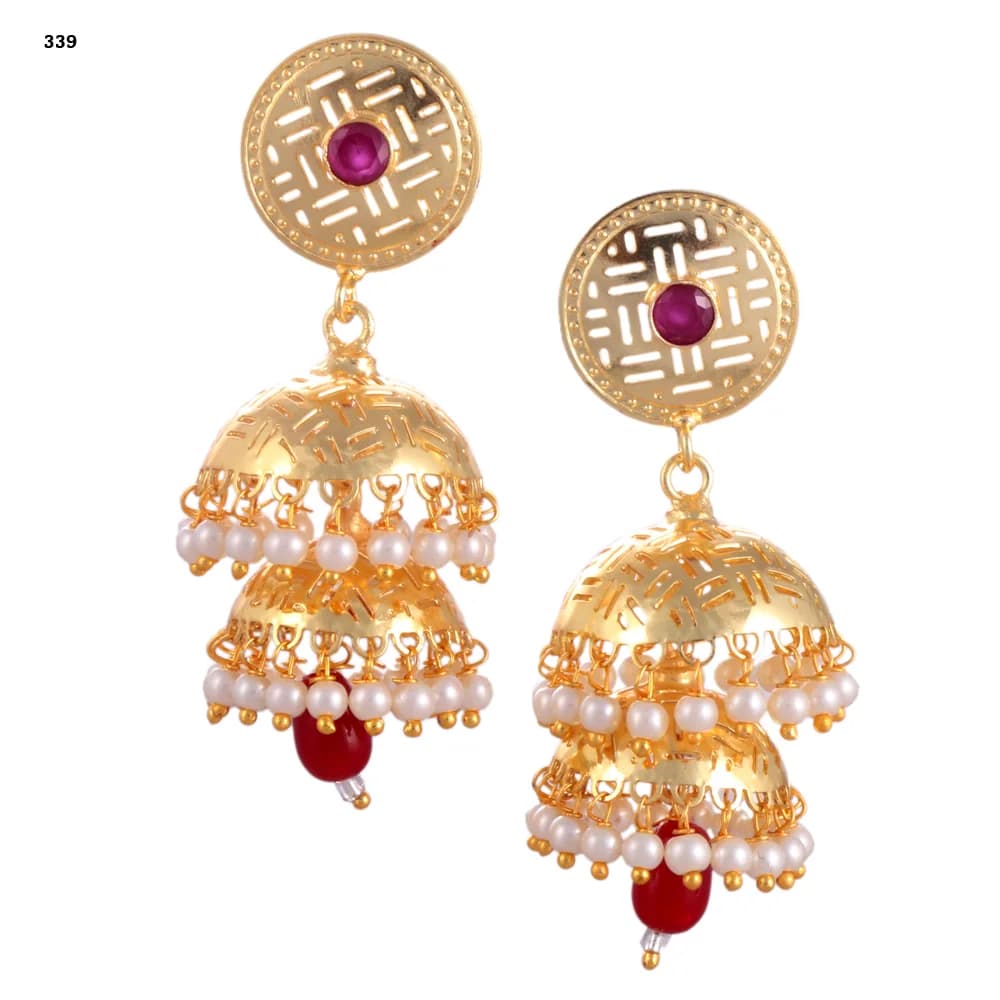 A pair of gold-plated jhumka earrings — a pierced disc stud set with a red stone above two stacked perforated domes, both pearl-fringed, with a red glass teardrop at the centre